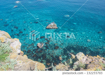 Clear turquoise sea water with rocks viewed from coastal cliff at Cape Kamui, Kozakicho, Hokkaido, Japan Clear turquoise sea water with rocks viewed from coastal cliff at Cape Kamui, Kozakicho, Hokkaido, Japan 132255783