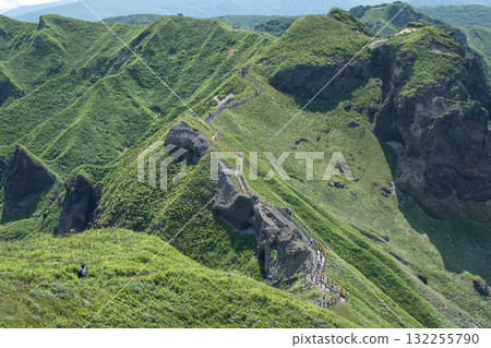 Hikers walking on green mountain trail in scenic natural landscape at Cape Kamui, Kozakicho, Hokkaido, Japan Hikers walking on green mountain trail in scenic natural landscape at Cape Kamui, Kozakicho, Hokkaido, Japan 132255790