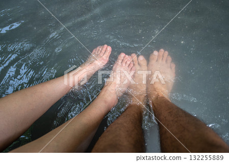 Couple soaking feet in water for relaxation and wellness River Oyunuma Natural Footbath, Noboribetsu, Hokkaido, Japan 132255889