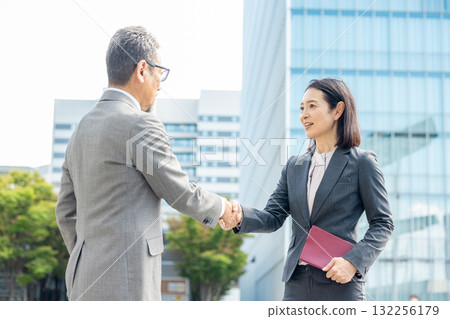 Handshake men and women in suits Handshake men and women in suits 132256179