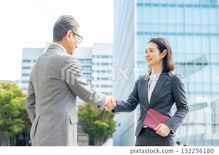 Handshake men and women in suits Handshake men and women in suits 132256180