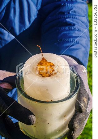 Person Holding Ice Candle with Autumn Leaf Inside DIY Decoration Person Holding Ice Candle with Autumn Leaf Inside DIY Decoration 132256353