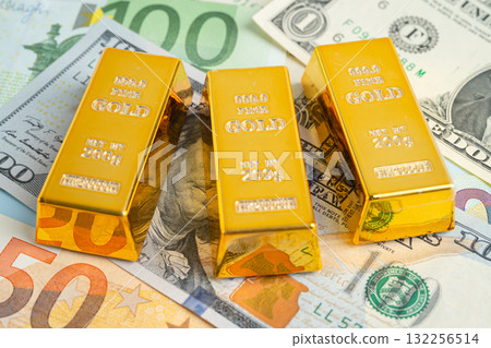 Gold bars on US dollar banknote money, finance trading investment business currency. Gold bars on US dollar banknote money, finance trading investment business currency. 132256514
