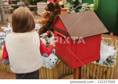 A child near a mailbox for Santa Claus A child near a mailbox for Santa Claus 132257000