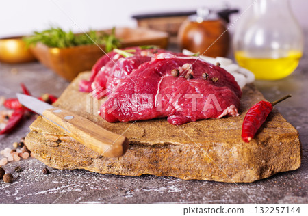 Raw meat on a table with spices Raw meat on a table with spices 132257144