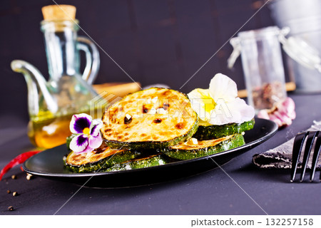 Roasted zucchini slices, rings, close-up view. 132257158