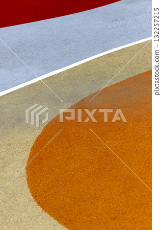 Abstract playground surface. Artistic outdoor rubber form with orange, blue painted rounded geometry 132257215