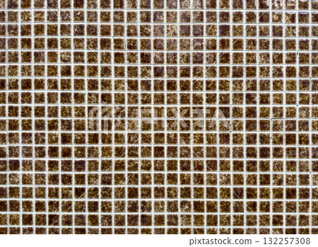 Mosaic tile pattern forms geometric grid. Small square ceramic brown tiles create textured Mosaic tile pattern forms geometric grid. Small square ceramic brown tiles create textured 132257308