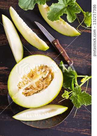 Wooden board with ripe cut melons 132257386