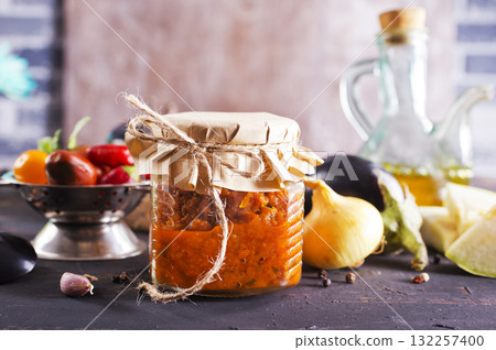 Dish with squash caviar dark background. Squash spread, zucchini caviar and ingredients. Healthy food. Top view Dish with squash caviar dark background. Squash spread, zucchini caviar and ingredients. Healthy food. Top view 132257400