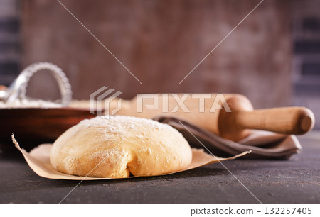 Fresh dough on a board 132257405
