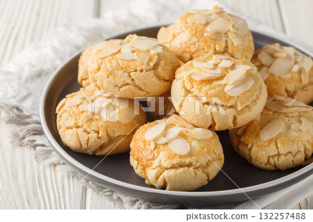 Crumbly cracked almond cookies close-up in a plate. Horizontal 132257488