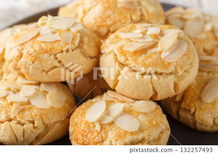 Homemade cracked almond flake cookies close-up in a plate. Horizontal 132257493