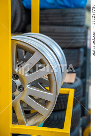 Closeup of clean car rims stacked in a tire workshop. Seasonal wheel replacement and maintenance in auto service before winter in Czech Republic. Closeup of clean car rims stacked in a tire workshop. Seasonal wheel replacement and maintenance in auto service before winter in Czech Republic. 132257786