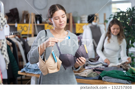 Young woman choosing bra in store Young woman choosing bra in store 132257808