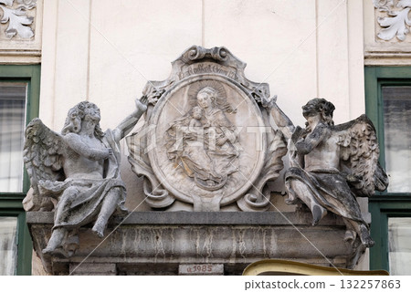 Virgin Mary with baby Jesus, statue on the house facade in Graz, Styria, Austria Virgin Mary with baby Jesus, statue on the house facade in Graz, Styria, Austria 132257863