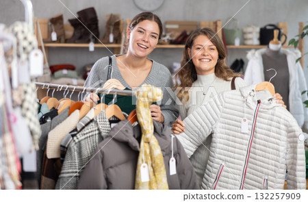 Two young women choosing outerwear in store Two young women choosing outerwear in store 132257909