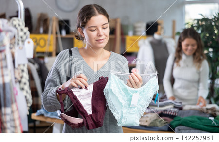 Young woman chooses panties in clothing store 132257931