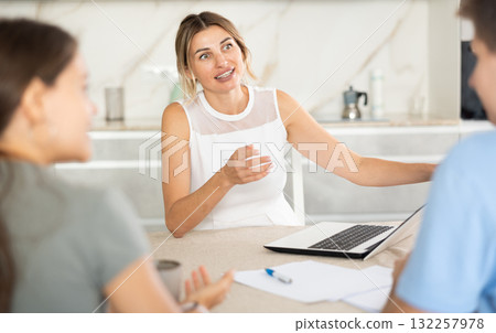 An insurance agent tells young couple the terms of property and life insurance 132257978
