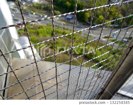 Scenic View of Highway and Greenery Through a Wire Fence from Above 132258385