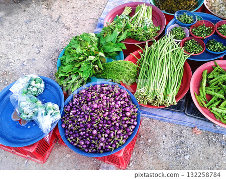 A Cheerful Smiling Face Drawn on Frothy Hot Drink in Orange Mug on Woven Mat 132258784