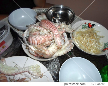Table Setup with Fresh Sea Cockroach and Bean Sprouts for a Seafood Meal 132258786