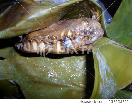 Close Up of a Roasted Insect Wrapped in a Green Leaf for Display Close Up of a Roasted Insect Wrapped in a Green Leaf for Display 132258793