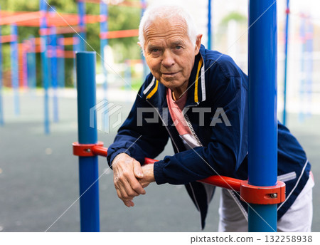 Portrait of sporty grandfather on playground in summer park 132258938