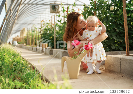 Mother and daughter are in the greenhouse Mother and daughter are in the greenhouse 132259652