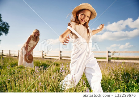 Running, having fun. Beautiful mother with her daughter on the farm Running, having fun. Beautiful mother with her daughter on the farm 132259676