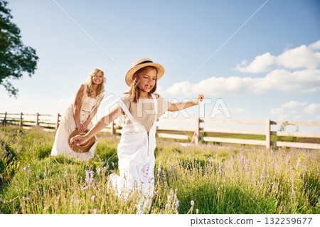 Running, having fun. Beautiful mother with her daughter on the farm Running, having fun. Beautiful mother with her daughter on the farm 132259677