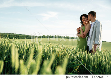 Non urban scene. Lovely couple are on the agricultural field together Non urban scene. Lovely couple are on the agricultural field together 132260106
