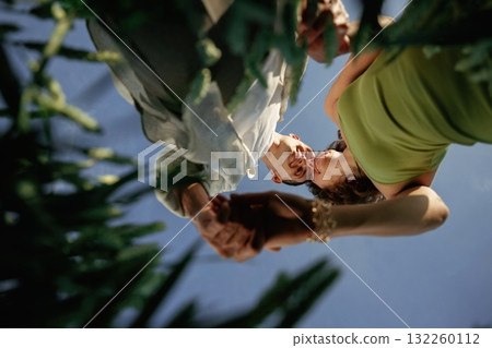 View from below of couple that is standing in the agricultural field View from below of couple that is standing in the agricultural field 132260112