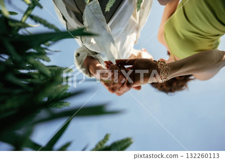 View from below of couple that is standing in the agricultural field View from below of couple that is standing in the agricultural field 132260113