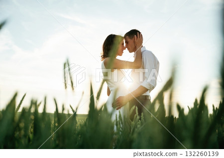 High wheat. Lovely couple are on the agricultural field together 132260139