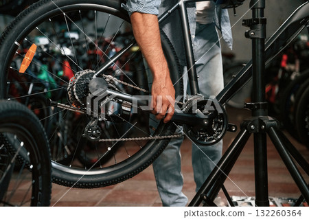 Close up view of man's hands that is repairing bicycle Close up view of man's hands that is repairing bicycle 132260364