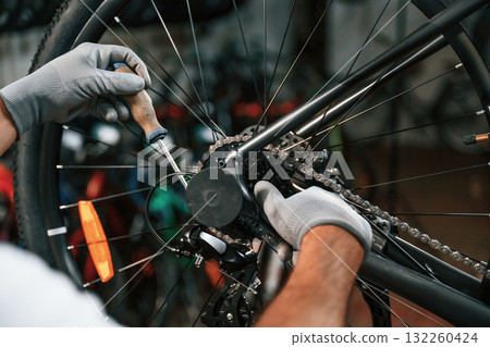 The derailleur issue, fixing. Close up view of man's hands that is repairing bicycle The derailleur issue, fixing. Close up view of man's hands that is repairing bicycle 132260424