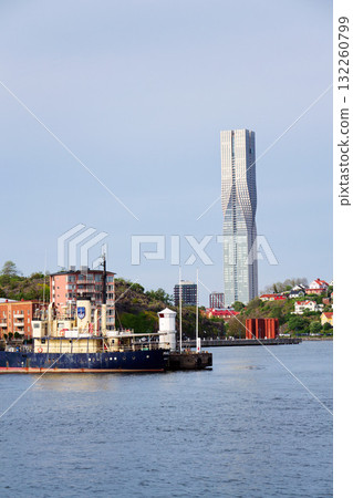 Colony of small wooden historic houses on the Slottsberget mountain with the tallest Scandinavian building Karlatornet skycraper in Lindholmen, Gothenburg, Sweden 132260799