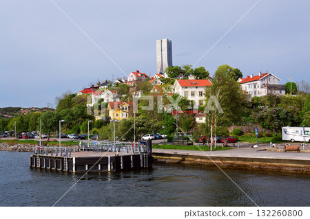 Colony of small wooden historic houses on the Slottsberget mountain with the tallest Scandinavian building Karlatornet skycraper in Lindholmen, Gothenburg, Sweden 132260800