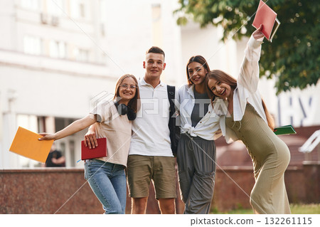 Cheerful, having fun. Group of students are outside together 132261115