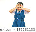 Playful Asian Schoolgirl Smiling and Holding Her Head in Blue Uniform on White Background 132261133