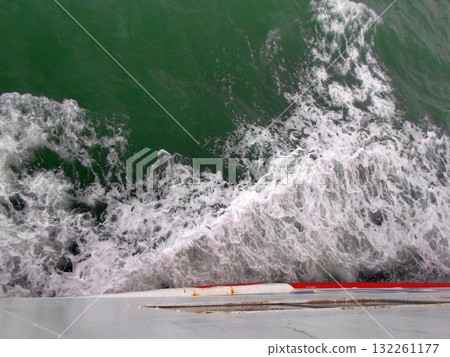 Close Up of Rough Seas Crashing Against the Side of a Boat During a Voyage 132261177