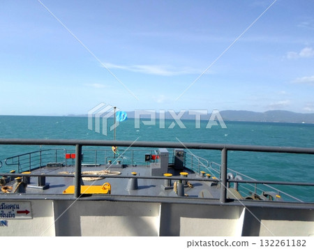 Scenic Ocean View from a Ship's Deck with Distant Mountains and Clear Sky 132261182