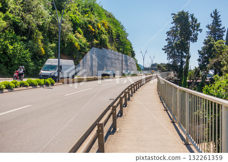 Sunny street with hillside view. Urban living, nature integration, and relaxed Mediterranean lifestyle in a coastal neighborhood. 132261359