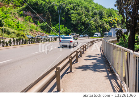 Sunny street with hillside view. Urban living, nature integration, and relaxed Mediterranean lifestyle in a coastal neighborhood. 132261360