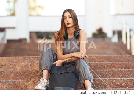 Sitting on the stairs. Beautiful female student is outdoors near the university Sitting on the stairs. Beautiful female student is outdoors near the university 132261395