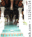 Grand Temple Entrance with Teal Tiled Floor and Ornate Columns Under Tiled Roof 132261514