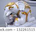 Ornate White Elephant Sculpture with Golden Accents on a Stone Pedestal 132261515