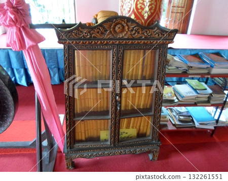 Ornate Wooden Cabinet in Temple Holding Ancient Scrolls with Red Carpet Ornate Wooden Cabinet in Temple Holding Ancient Scrolls with Red Carpet 132261551