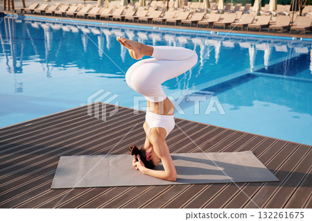 On the head, side, view. Fitness woman is near the pool On the head, side, view. Fitness woman is near the pool 132261675